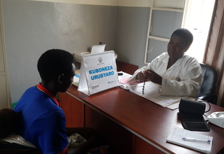 Photo: A Congolese refugee at a health facility receives family planning information and services from a nurse in Mugombwa Camp. 