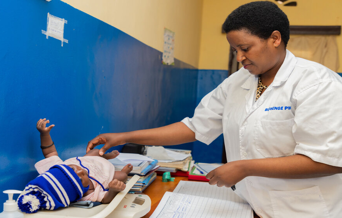 Mukandayisenga Mariane, Mentor at Kamonyi Health Center has taking care of a baby 