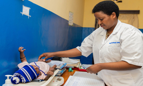 Mukandayisenga Mariane, Mentor at Kamonyi Health Center has taking care of a baby 