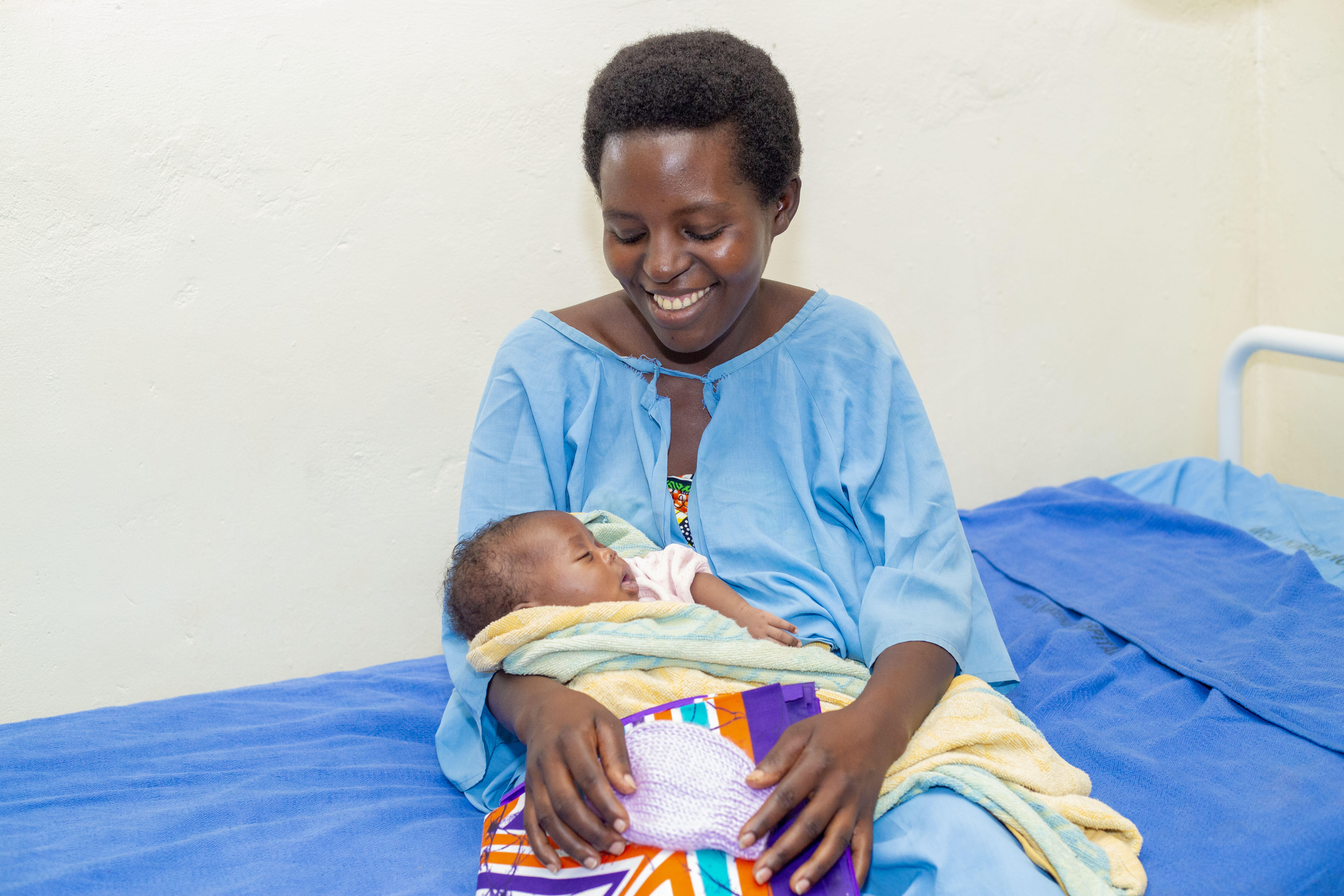 A happy mother smiling at her new born at Kirehe Hospital, Rwanda (Photo: Andre Rugema, RBC, 2019)