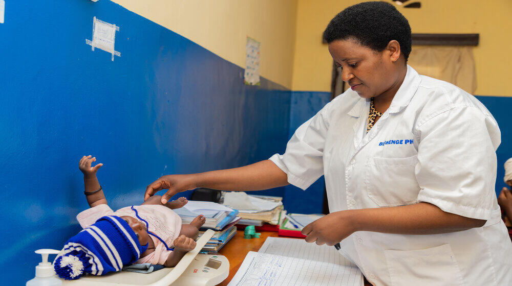 Mukandayisenga Mariane, Mentor at Kamonyi Health Center has taking care of a baby 